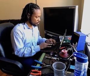 Bradford Webb sitting and working on his computer.