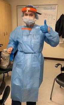 A medical professional wearing a face shield made by the Mason team. She is giving a thumbs up to the camera.