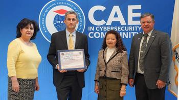 Three government representatives stand with a George Mason University professor, who is holding a plaque
