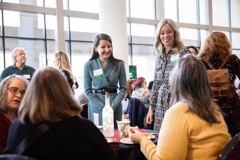 faculty and staff mingling at donor breakfast