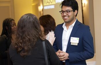 A student speak with a dean at GMU's Annual Scholarship Dinner at the dinner