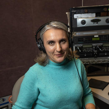 Anamaria Berea wearing headphones in the WGMU studio